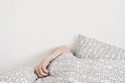 Adult sleeping peacefully in a bed with patterned bedding