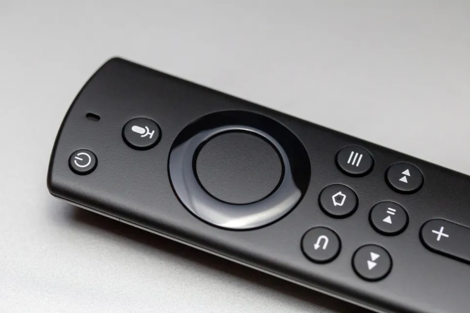 Close-up of a black streaming media remote control with navigation buttons