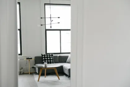 Tidy minimalist living room with grey sofa and round coffee table after decluttering